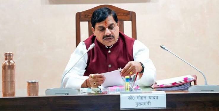 आधी रात के समय रोशनी से जगमगाता भोपाल स्थित मध्य प्रदेश मंत्रालय (वल्लभ भवन) का मुख्य प्रशासनिक परिसर और टेबल पर रखी फाइलों का ढेर।